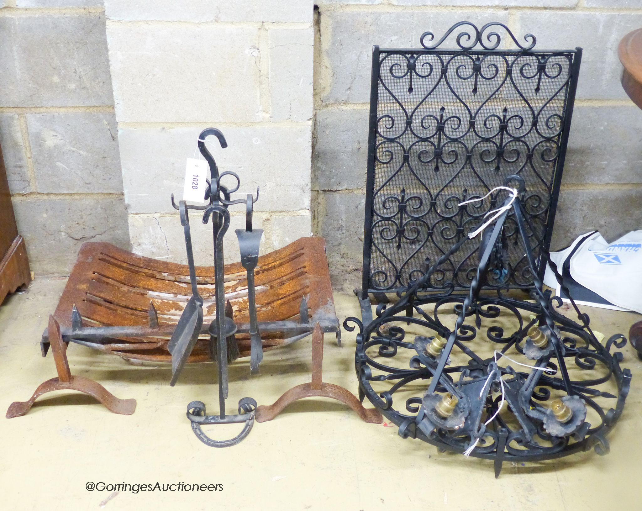 A cast and wrought iron fire grate, spark guard, fire implements, a light fitting and wall lights